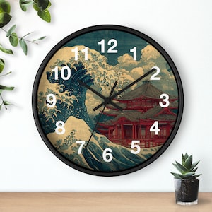 May include: A round wall clock with a black frame and a white clock face featuring a large blue ocean wave and a red traditional building. The clock has black hour, minute, and second hands with white Arabic numerals from one to twelve.
