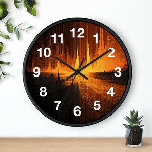 May include: A round wall clock with a black frame and a face featuring an abstract, vertical orange and black gradient design. The clock has white Arabic numerals from 1 to 12 and black hour, minute, and second hands centered on the dial.