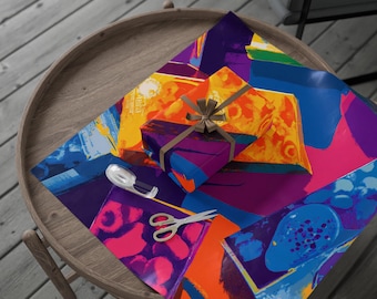 May include: A wrapped gift with a brown ribbon sits atop colorful wrapping paper with an abstract design in shades of orange, blue, purple, and yellow. Scissors and tape are also on the wrapping paper, ready for use. The gift and paper are on a wooden table.