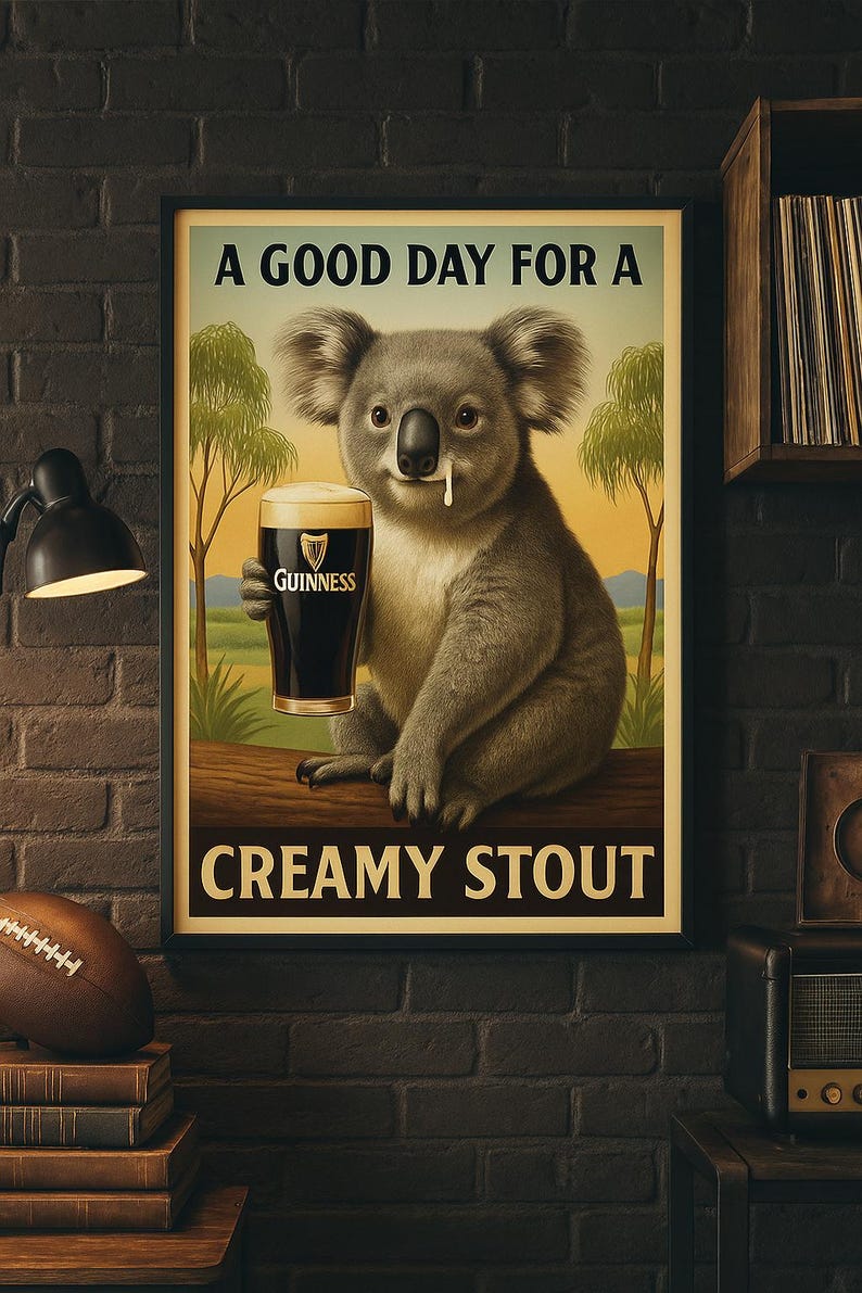 May include: Poster featuring a koala holding a pint of Guinness stout. The koala is sitting on a log with a landscape background. Text reads "A Good Day For A Creamy Stout."