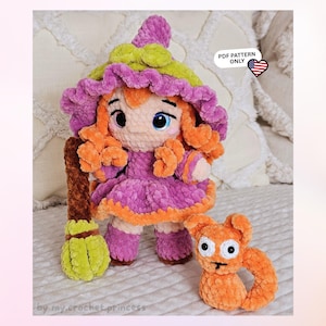 May include: A crochet doll with orange hair, wearing a purple and lime green hat and dress, holding a brown and lime green broom. Beside the doll is a small orange crochet cat. The image includes the text PDF PATTERN ONLY with a US flag icon.