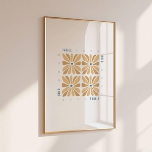 May include: Framed art print with a gold frame. The artwork features four stylized tan flowers with blue centers, arranged in a square. The words "INHALE," "HOLD," and "EXHALE" are written in blue. Small blue circles surround the flowers.