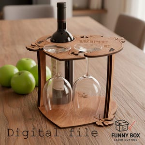May include: A wooden wine holder with space for a bottle and two glasses. The holder has a leaf design and the word "WINE" cut into the top. A bottle of red wine and two wine glasses are in the holder. The words "Digital file" are at the bottom.