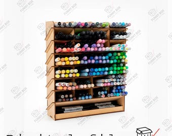 May include: A light-colored wooden desk organizer with multiple horizontal shelves and vertical dividers, filled with a large collection of colorful markers arranged by color. The unit features a slanted side profile and a wide bottom shelf.