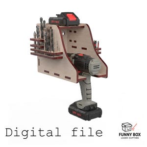 May include: A wall-mounted wooden tool organizer featuring a light wood finish with dark brown edges. It holds a cordless drill, a battery pack, and various drill bits in side slots. The text "Digital file" and "FUNNY BOX LASER CUTTING" appear below.