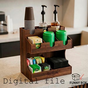 May include: A dark brown wooden coffee and tea station organiser. It has compartments for cups, tea bags, lids, and sugar packets. Two clear bottles with black pumps and green lids are also visible. The text "Digital file" is at the bottom.