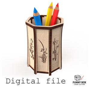 May include: A wooden pencil holder with a hexagonal design, featuring decorative floral and bamboo cutouts. The holder contains blue, yellow, and red pencils. The text "Digital file" is displayed at the bottom.