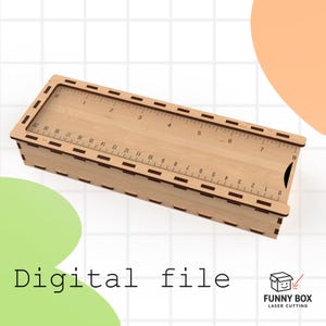 May include: A wooden pencil box with a ruler design on the lid, featuring measurements in inches. The box is made of light-colored wood with dark brown accents and the text "Digital file". The Funny Box Laser Cutting logo is in the bottom right corner.