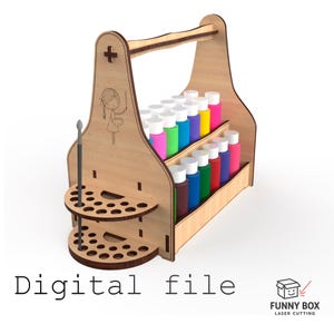 Puede incluir: Un organizador de botellas de pintura de madera con asa, que contiene varias botellas de pintura de colores. El organizador tiene dos portacepillos circulares y una ilustración decorativa de una niña con un pincel. El texto "Digital file" está en la parte inferior.