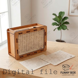 May include: A rectangular wooden savings box featuring a clear front panel with a grid of printed numbers and a slot on top. Two additional paper sheets with matching number grids are placed in front of the box, which displays the text 10,000.