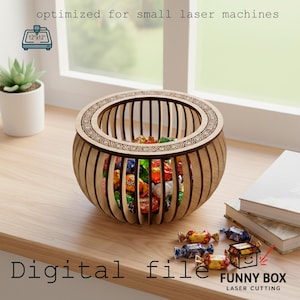 May include: A wooden, laser-cut bowl filled with colorful candies. The bowl has a decorative rim and vertical slats. Text on the image reads "optimized for small laser machines" and "Digital file". The design is 12" x 12" and is from Funny Box Laser Cutting.