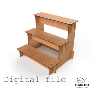 May include: A three-tiered wooden display stand with a light brown finish. The stand has a rectangular shape with three steps, each with a flat surface. The text "Digital file" is at the bottom. The Funny Box Laser Cutting logo is in the bottom right corner.