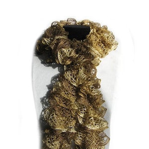 May include: A gold and brown crocheted scarf with a ruffled design.
