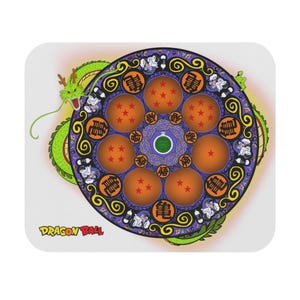 May include: A circular mousepad featuring a Dragon Ball design. The design includes seven orange spheres with stars, a green dragon, and the text "Dragon Ball". The background is white.