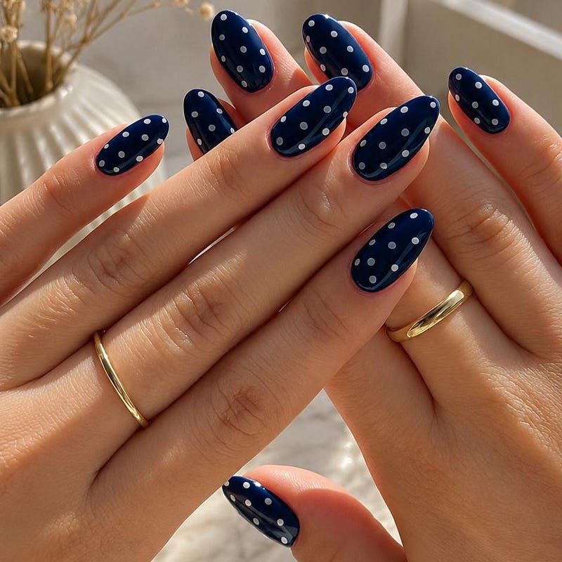 White polka dots on navy blue winter nails