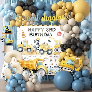 May include: A festive birthday party decoration set with a construction theme. Includes a banner that reads "Happy 3rd Birthday", balloons in blue, yellow, black, and white, and construction vehicle decorations.
