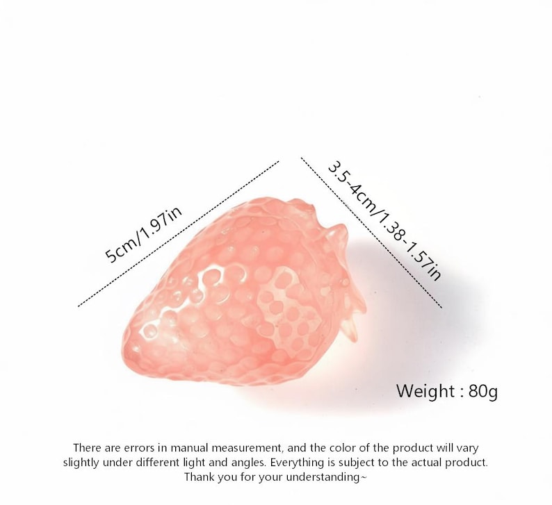 May include: A translucent, pink strawberry-shaped object. The strawberry measures 5cm/1.97in in length and 3.5-4cm/1.38-1.57in in width. It weighs 80g. The image includes text about measurement errors and color variations.