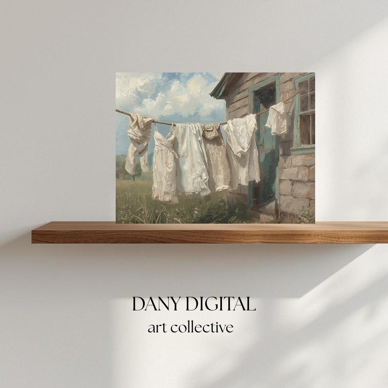 May include: A painting in a vintage style shows white laundry hanging on a washing line, set against a weathered building and a bright blue sky. The artwork, labelled "DANY DIGITAL art collective", evokes nostalgia and rural life.