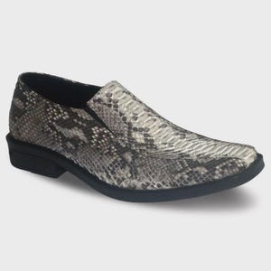May include: A single slip-on shoe with a snakeskin pattern in shades of gray, black, and white. The shoe has a rounded toe and a low, black sole. The design resembles a loafer, suitable for casual or semi-formal wear.