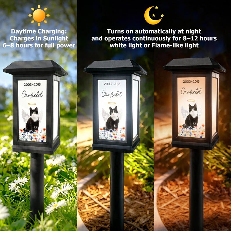 May include: Black solar-powered memorial garden light with a rectangular frame. The light features a black and white cat with angel wings and the name "Garfield" with the years 2003-2013. The light charges in sunlight and turns on automatically at night.