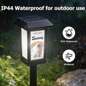 May include: Black solar-powered outdoor light with a rectangular frame. The light features a picture of a cat with the name "Sammy" and the years "2016-2024". The text "IP44 Waterproof for outdoor use" is at the top.