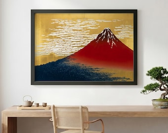 May include: Framed art print featuring a stylized depiction of Mount Fuji. The artwork showcases a vibrant red mountain peak against a gold background with white cloud formations. A dark blue forest base completes the landscape.