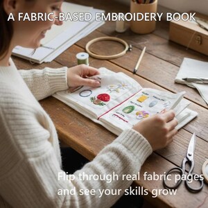 Puede incluir: Un libro de bordado abierto con p&aacute;ginas de tela, con dise&ntilde;os cosidos coloridos de una fresa, flores y otros motivos. El texto "A FABRIC-BASED EMBROIDERY BOOK" est&aacute; en la parte superior. El texto "Flip through real fabric pages and see your skills grow" est&aacute; en la parte inferior.