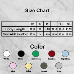 May include: A size chart showing body length and chest width measurements in inches, from XS to 2XL. The chart also displays a colour palette with options including white, black, Irish green, Carolina, light blue, pink, daisy, pepper, and grey.