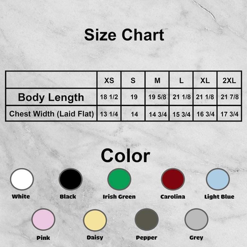 May include: A size chart showing body length and chest width measurements in inches, from XS to 2XL. The chart also displays a colour palette with options including white, black, Irish green, Carolina, light blue, pink, daisy, pepper, and grey.