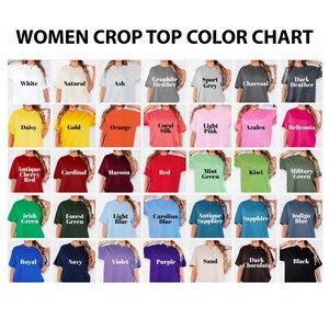May include: A women's crop top colour chart displaying a range of hues. The chart includes colours such as white, natural, ash, graphite heather, sport grey, charcoal, dark heather, daisy, gold, orange, coral silk, light pink, azalea, and heliconia.
