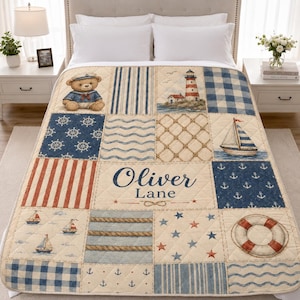 May include: A quilted bed blanket featuring a nautical theme with patchwork squares displaying a teddy bear in a sailor outfit, a lighthouse, sailboats, anchors, ship wheels, rope patterns, and a life preserver, with the name Oliver Lane printed.