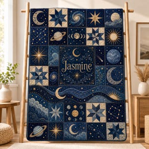 May include: A rectangular quilt featuring a dark blue celestial theme with various patches of stars, planets, moons, and geometric star patterns. The center panel displays the name Jasmine in gold script surrounded by a decorative botanical frame.