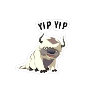 May include: A sticker featuring a cartoon bison-like creature with white fur, a brown head, and black horns. The text "YIP YIP" is above the creature in black letters. The sticker has a white border.