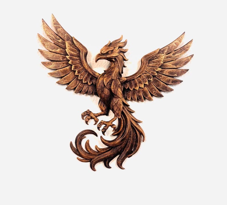 May include: A detailed, brown wooden carving of a phoenix with outstretched wings. The bird's feathers and tail are intricately carved, and its talons are extended. The phoenix is a symbol of rebirth and renewal.