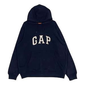 May include: A navy blue hoodie featuring the white text "GAP" across the chest. It has a front pocket and a drawstring hood. The hood's interior is orange. A classic, casual garment.