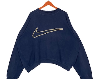 Sudadera vintage Nike con logo grande Swoosh, cuello redondo, azul marino, estilo holgado.