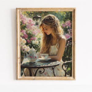 May include: A framed painting depicts a woman seated at a table, enjoying tea in a garden setting. The artwork features a floral teapot and teacup, with a backdrop of blooming pink and white flowers. The painting is in a gold frame.