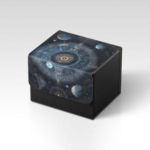 May include: A black box with a lid displaying a detailed, colourful illustration of a celestial map with planets, stars, and swirling patterns. The box has a textured, carbon fibre-like appearance.