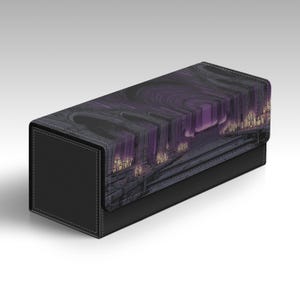 May include: A rectangular storage box with a black textured exterior and a flap lid featuring a printed illustration of a dark, stone-like architectural structure illuminated by glowing purple light and small clusters of warm yellow candles.