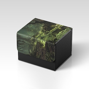 May include: A black storage box with a textured finish. The lid displays a detailed forest scene in shades of green and brown. The box is designed for storage and has a modern aesthetic.