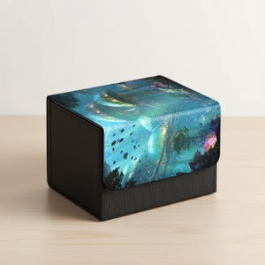 May include: A black and blue box with a fantasy landscape design. The top of the box features a vibrant, colorful illustration of a fantastical scene with swirling lights and trees. The sides are black.