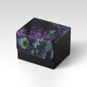 May include: A black, textured box with a hinged lid. The lid features a colorful illustration of stylized mushrooms in shades of green, blue, and purple against a dark background. The box is likely for storing small items.