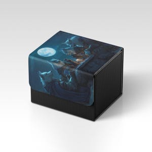 Könnte beinhalten: Eine schwarze, strukturierte Box mit einem Klappdeckel. Der Deckel zeigt eine Fantasy-Illustration von Wölfen, die den Mond in einer dunklen, blau getönten Szene anheulen. Die Box dient wahrscheinlich zur Aufbewahrung kleiner Gegenstände oder Sammlerstücke.