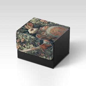 May include: A black card storage box with a detailed illustration of a rabbit knight in armor, holding a sword and shield. The artwork features a forest scene with green and orange foliage, creating a whimsical and fantasy theme.