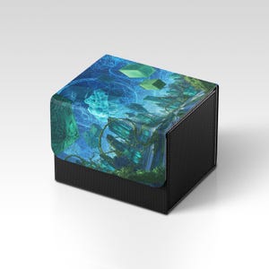 May include: A black box with a textured exterior and a colorful top. The top features a fantasy landscape with shades of blue, green, and teal. The design includes geometric shapes and a detailed, artistic illustration.