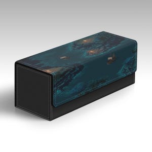 May include: A rectangular card storage box with a black base and a lid featuring a teal and blue underwater scene. The box has a textured appearance and white stitching.