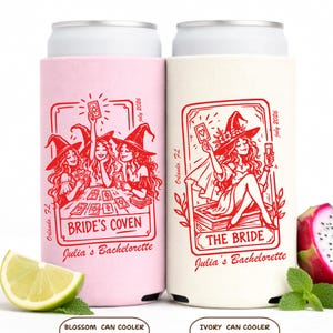 May include: Two can coolers, one pink and one ivory, with red witch-themed illustrations. The pink cooler reads "Bride's Coven" and the ivory cooler reads "The Bride". Both say "Julia's Bachelorette" and "Orlando, FL July 2026".