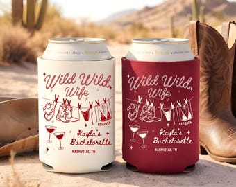 May include: Two can coolers, one white and one burgundy, with the text "Wild Wild Wife" and a clothesline design featuring cowboy boots, hats, and lingerie. The text "Kayla's Bachelorette, Nashville, TN" is also included.