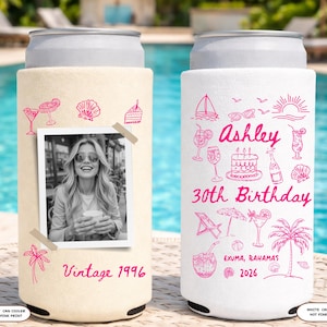 May include: Two can coolers, one ivory and one white, with hot pink designs. The ivory cooler has a photo and the text "Vintage 1996". The white cooler says "Ashley 30th Birthday" with illustrations and "Exuma, Bahamas 2026".