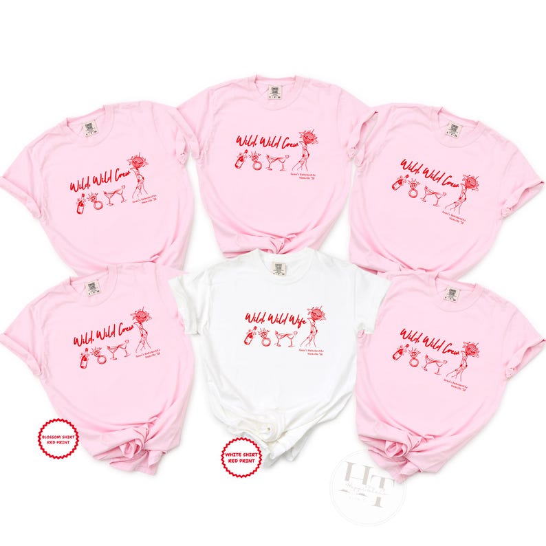 May include: Five short-sleeved t-shirts arranged in a group. Four shirts are light pink and one is white. Each shirt features a red graphic print with the text Wild Wild Crew or Wild Wild Wife, accompanied by illustrations of a bottle, ring, and glass.